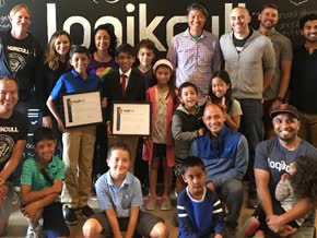 students and team posing infront of logikcull blackboard